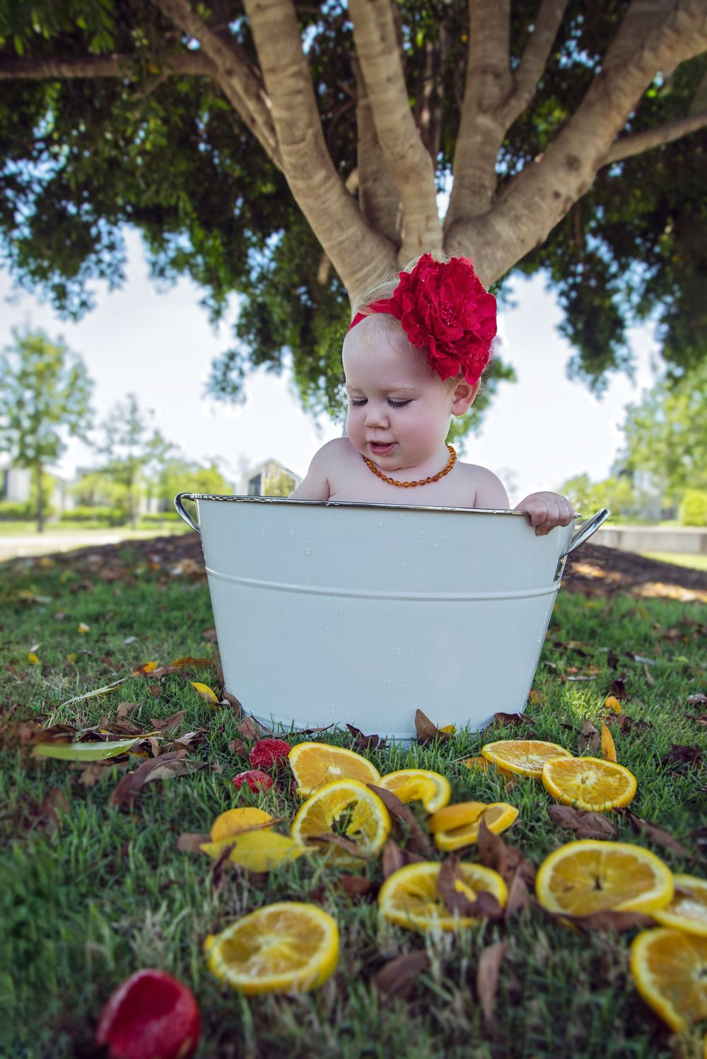 sisters year apart getting the same fruit baths in their 1st birthday photography session on the Gold Coast