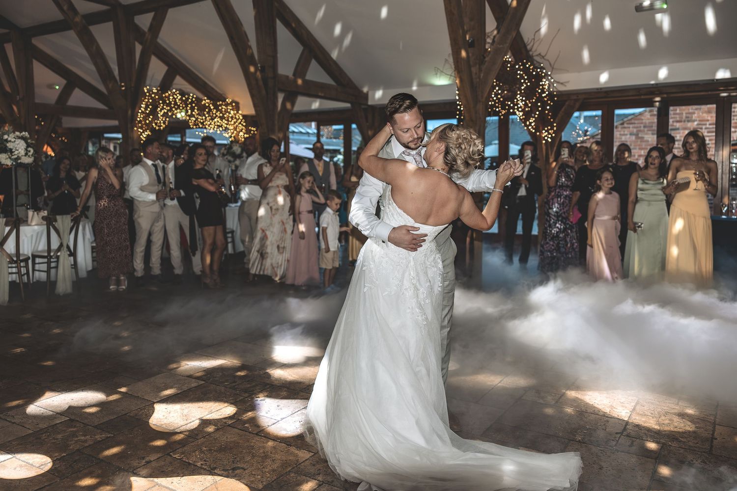 A couples first dance at Swancar Farm with onlooking family and friends with the added affect of a smoke machine.