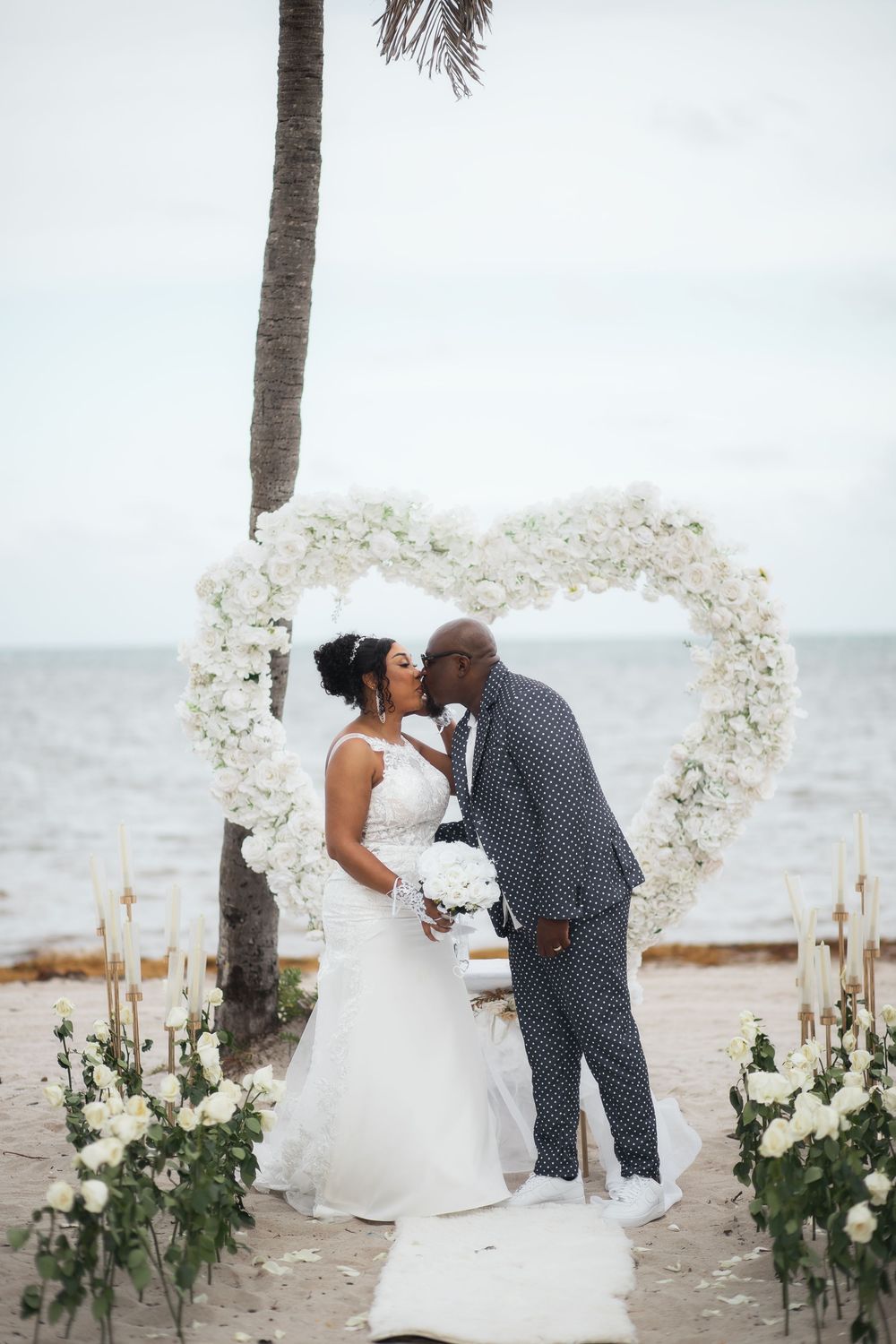 Newlywed couple first kiss in elopement wedding at Crandon Park Miami.