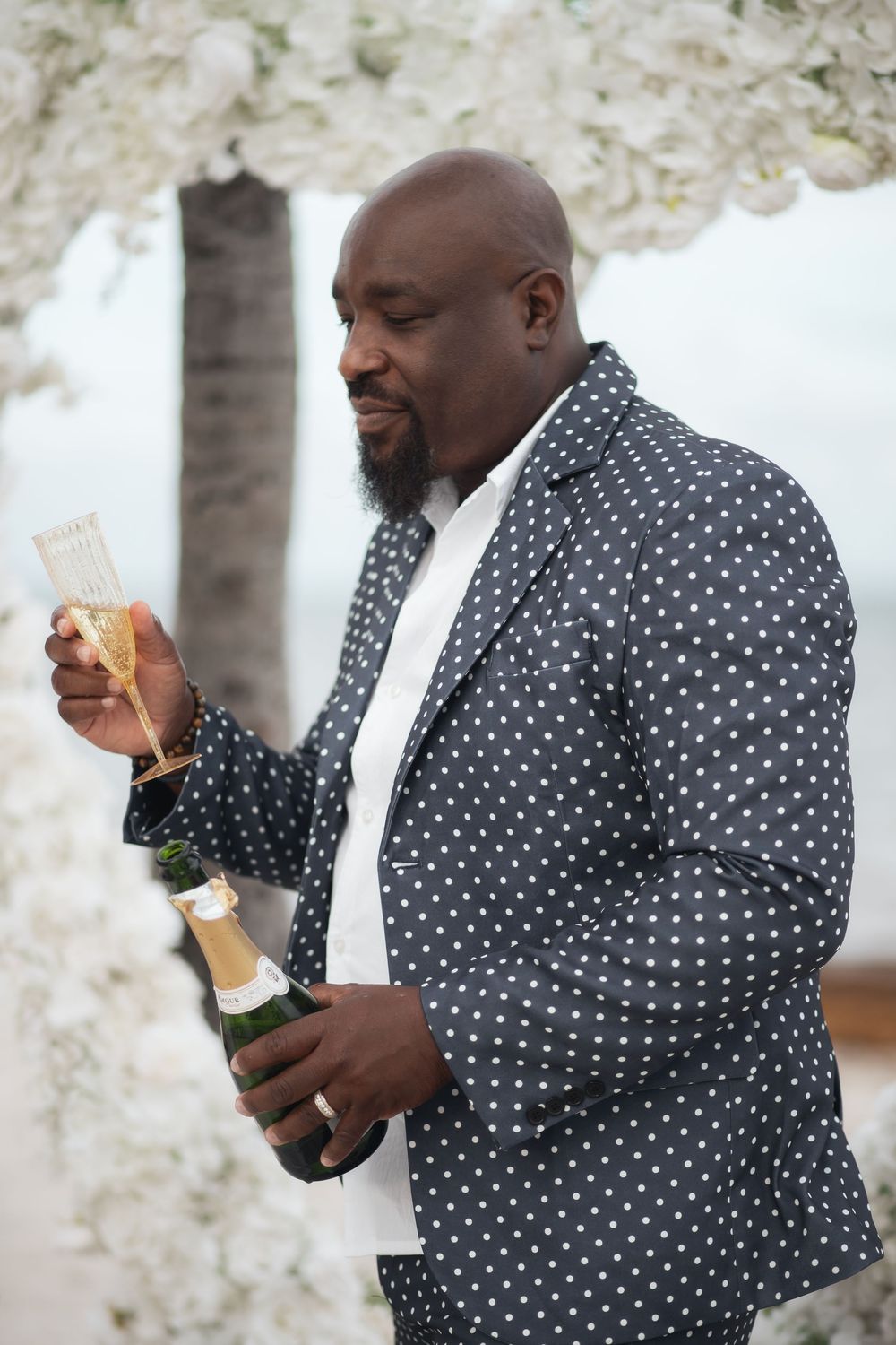 Newlywed groom toasting champagne in elopement wedding at Crandon Park Miami.