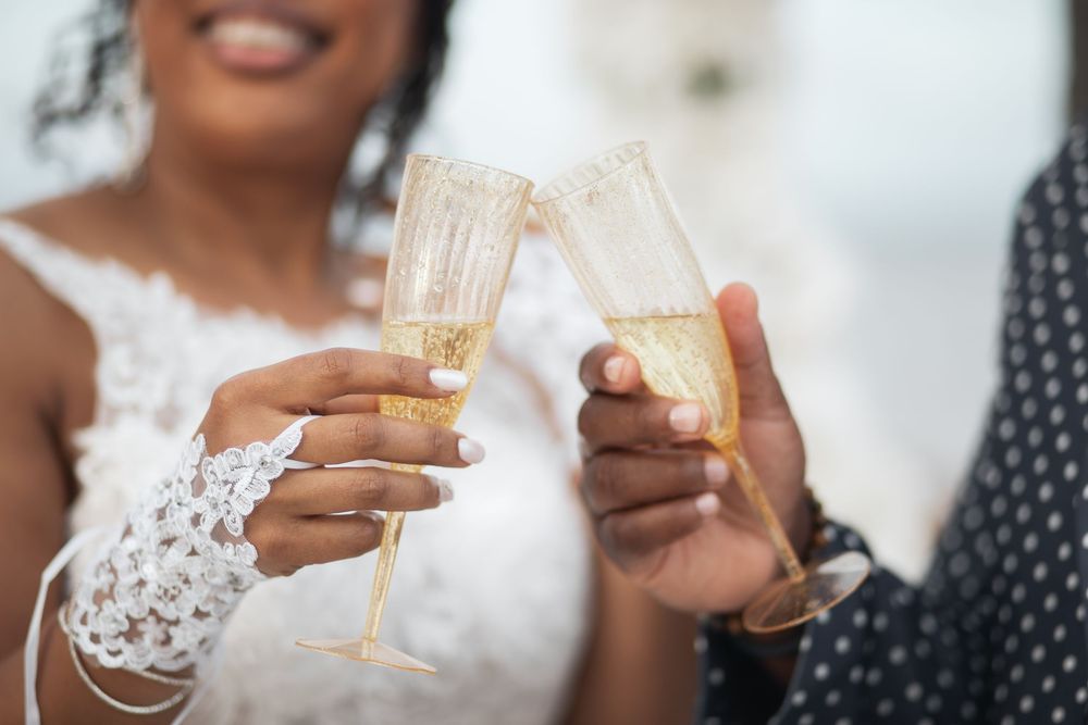 Newlywed couple toasting champagne in elopement wedding at Crandon Park Miami.