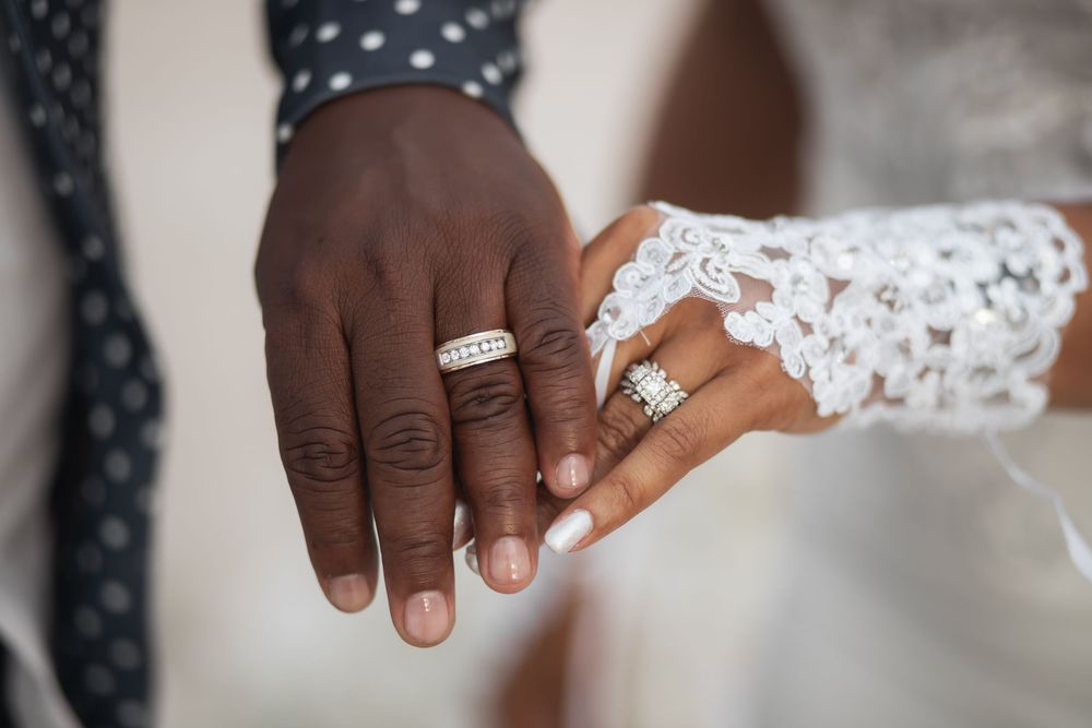 Couple showing wedding bands after elopement at Crandon Park Miami.