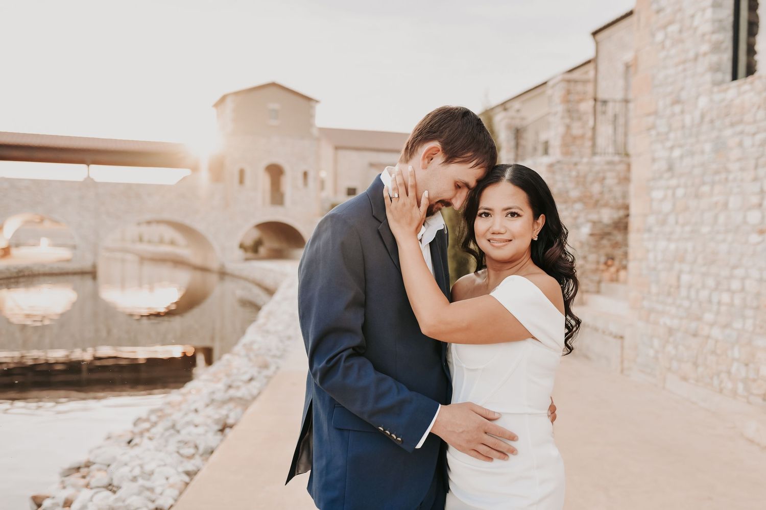 Golden hour couple portrait with sunlight glowing through the Chapel at Palacios architecture