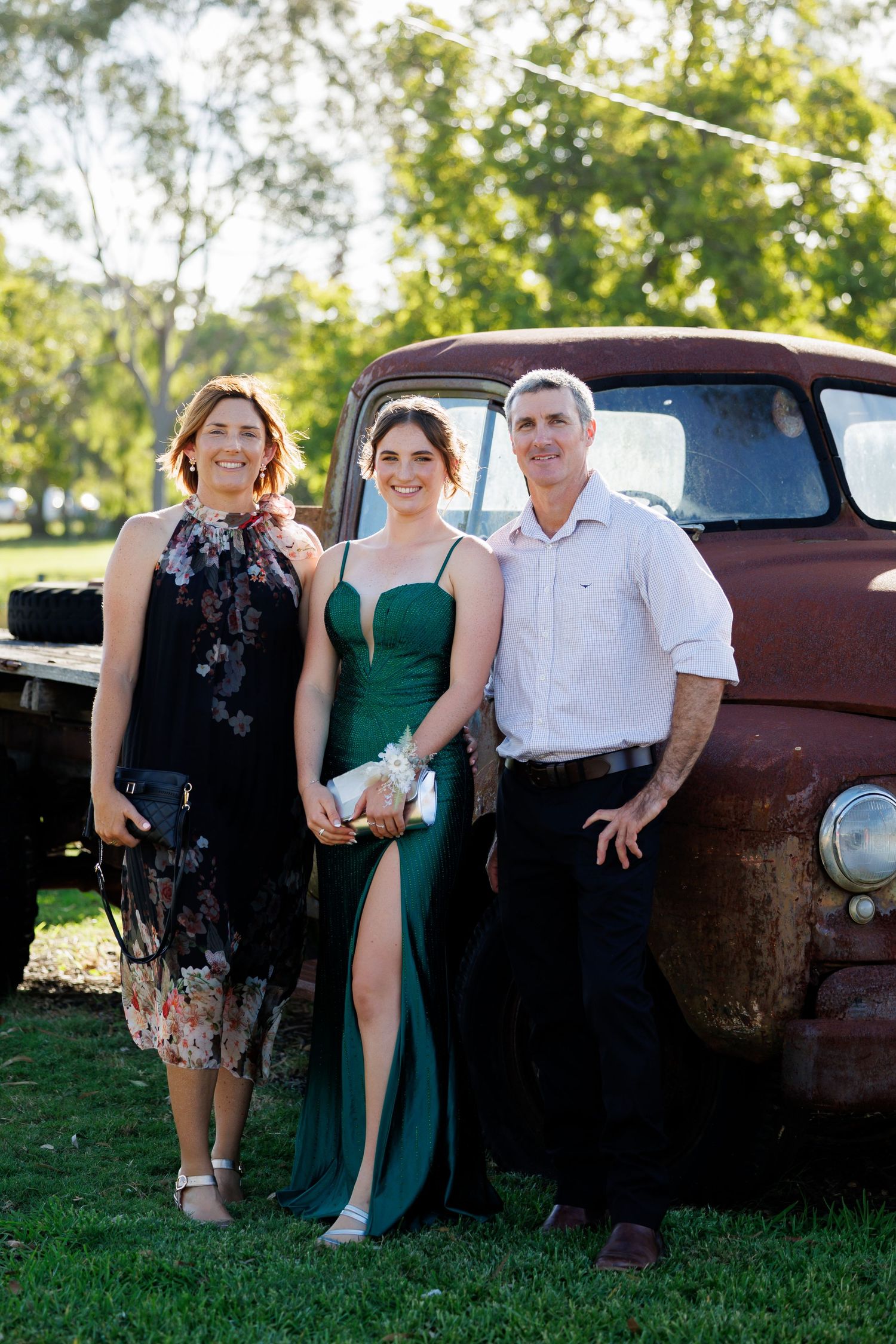 mother and father with their daughter on her formal day