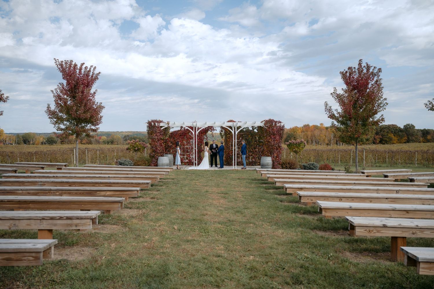 Bride & Groom enjoy a private, intimate ceremony amongst the rolling vineyards at Rustic Roots Winery in Scandia, MN.