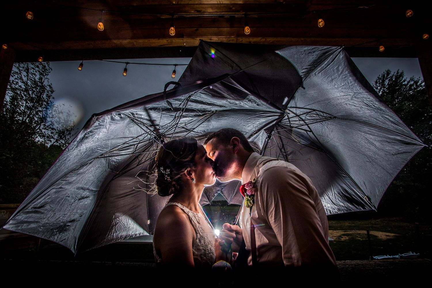 Romantic evening portraits under illuminated umbrellas creating magical lighting effects.