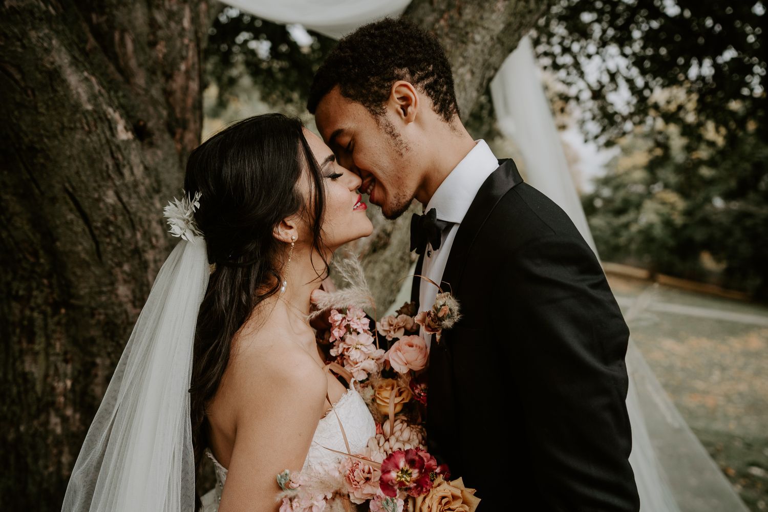 bride and groom kiss at ceremony