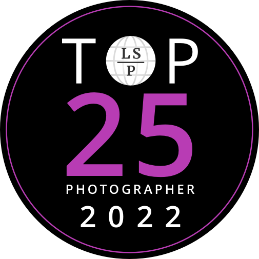 Black circular badge with white text showing "TOP 25 PHOTOGRAPHER 2022" and purple accents.