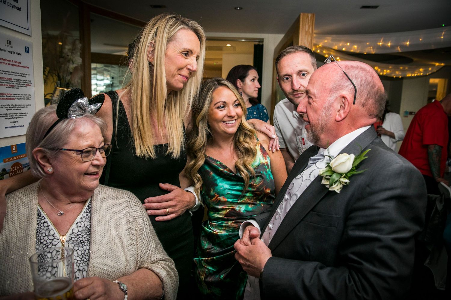 Wedding reception candid moments showing guests celebrating at an indoor venue.