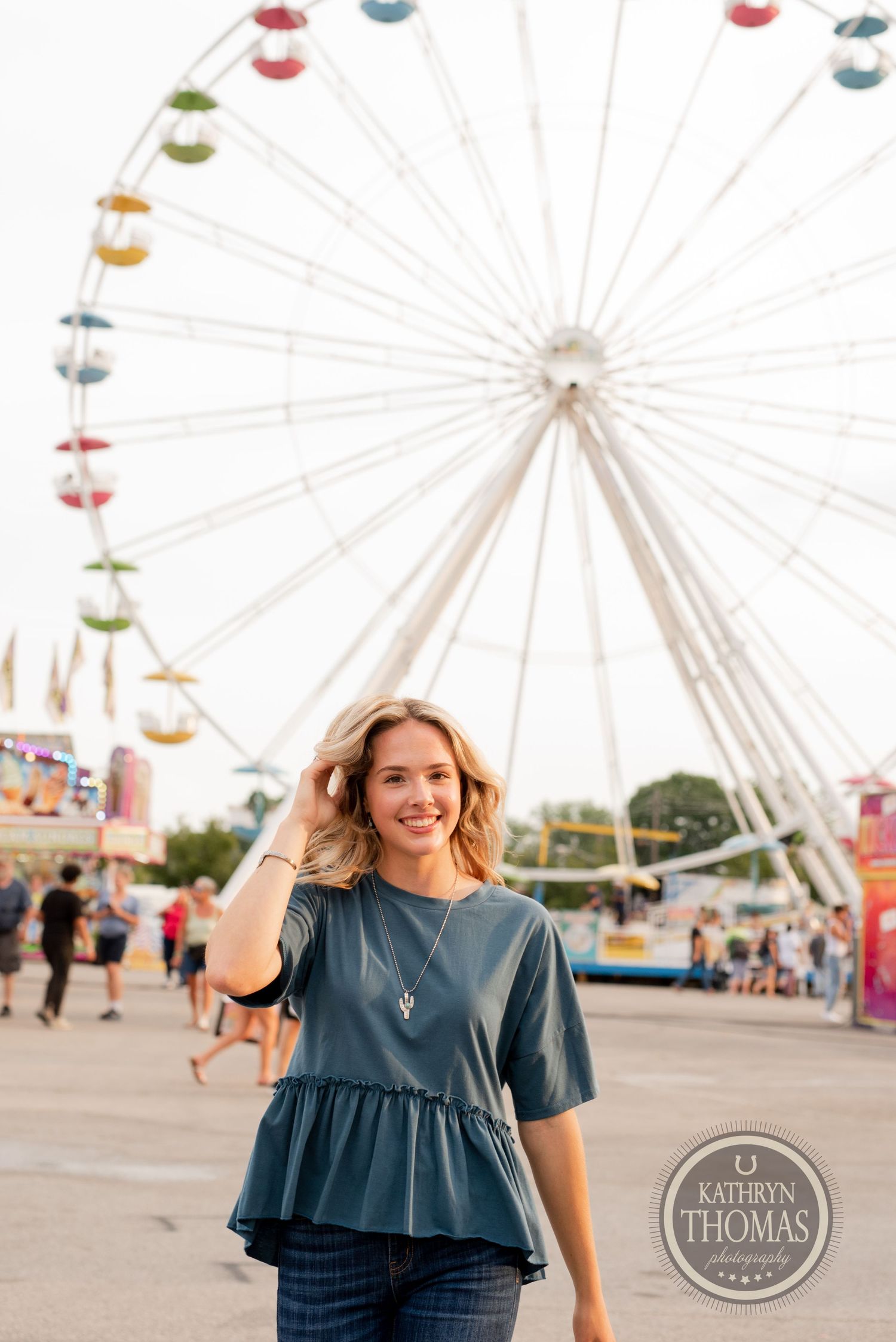 Blue peplum top and jeans outfit captured with ferris wheel in background at carnival.