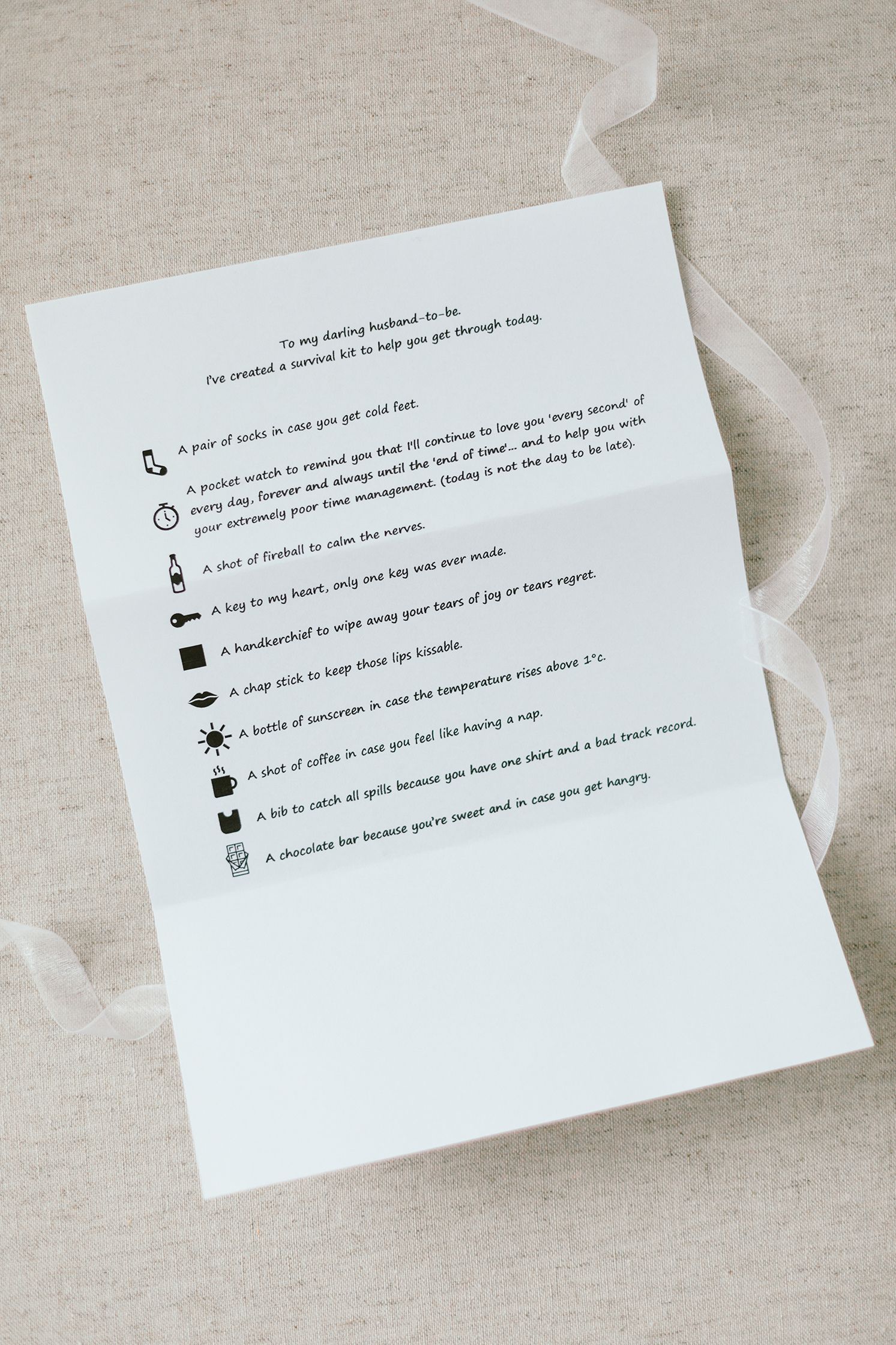 White paper with list of icons and text instructions on linen background.