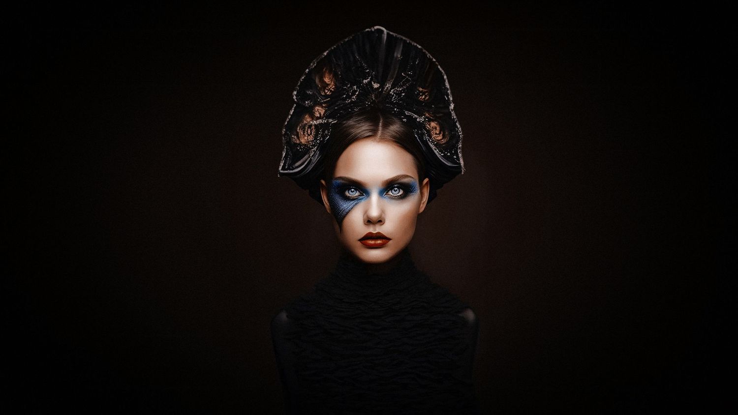 Dark artistic portrait with elaborate black headpiece in classical style.