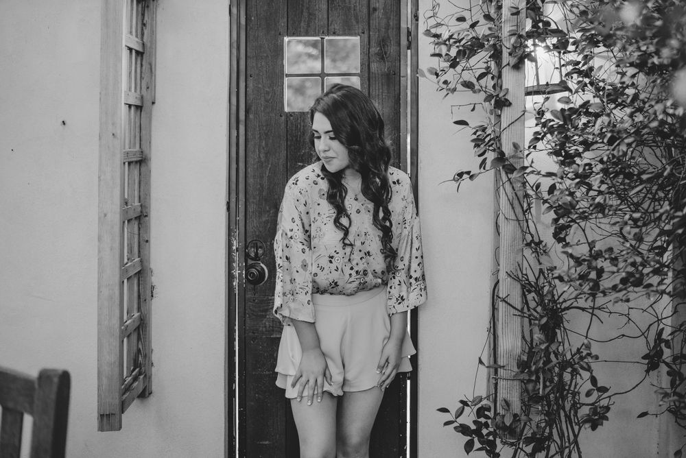 girl looking down to the side for a photo. Casa Polonia. Weslaco, Texas. Wedding photography