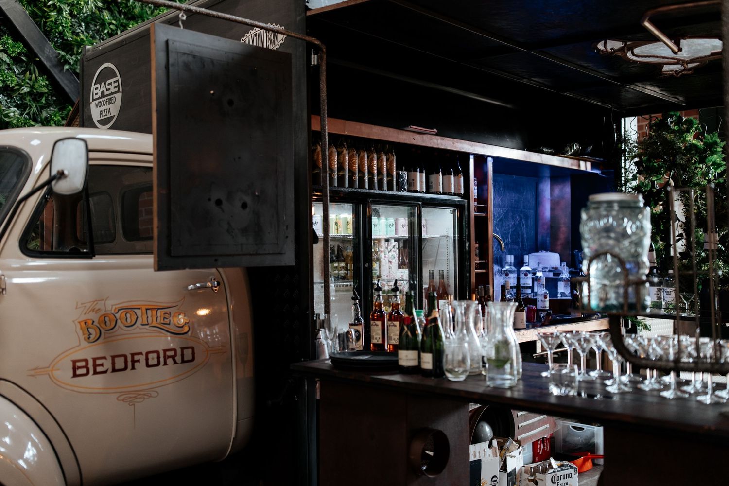 Vintage Bedford truck converted into mobile bar with glassware display.