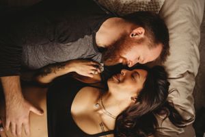 Intimate close-up portrait captured in soft, moody lighting.