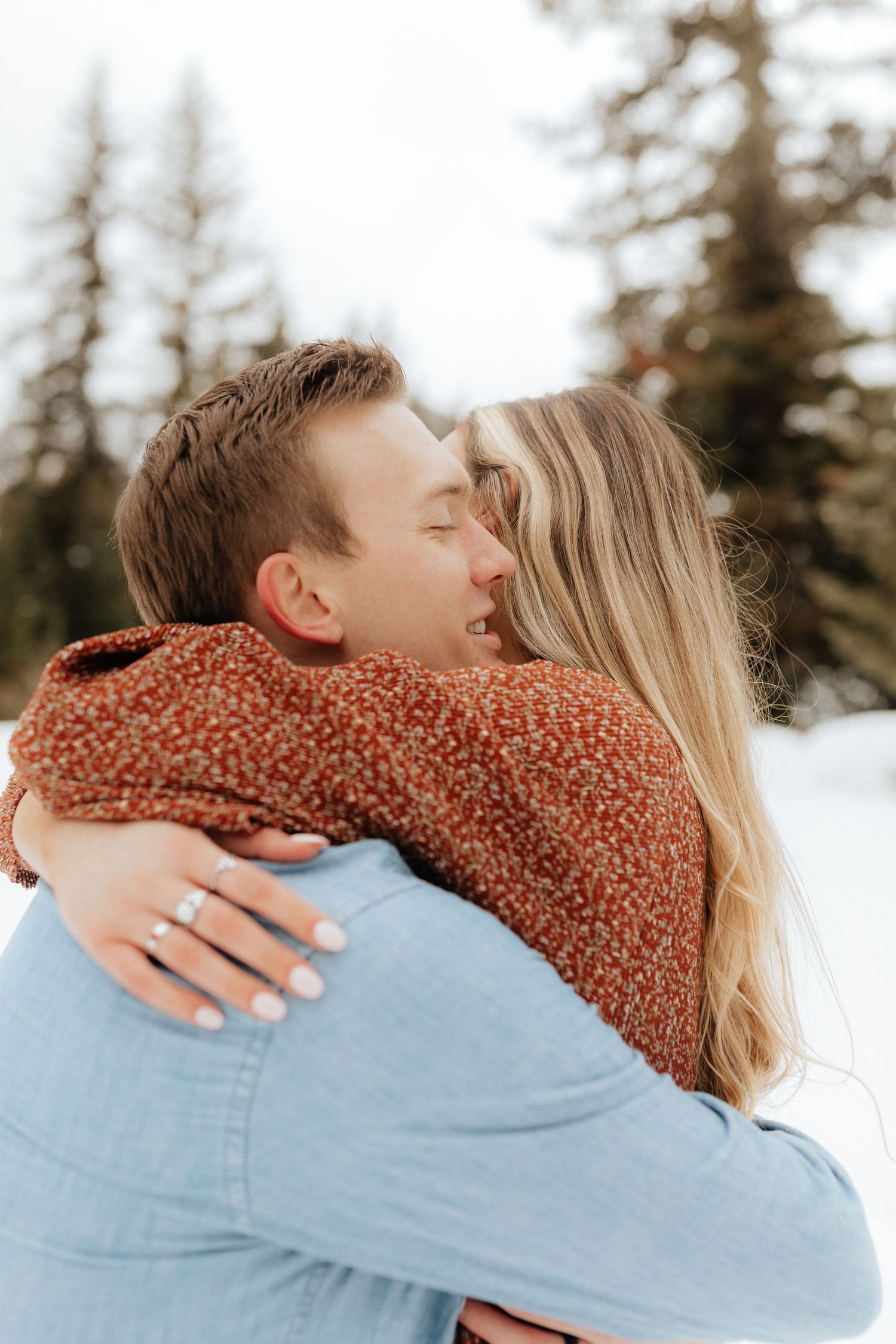 Woman hugging man in winter forest