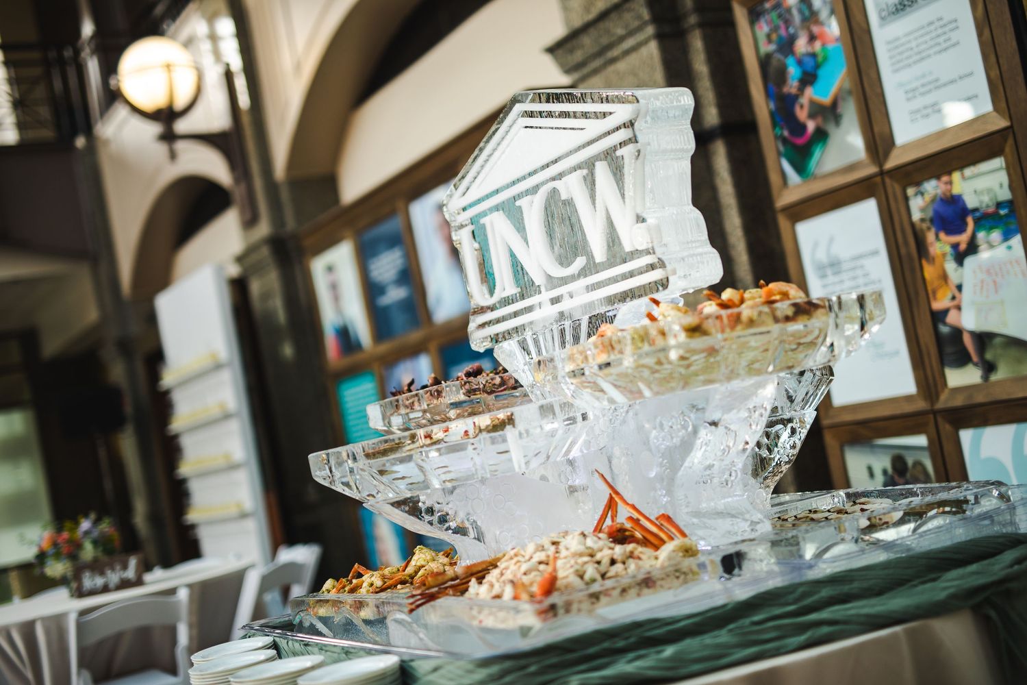 Elegant catering display with tiered serving platters under arched architecture.