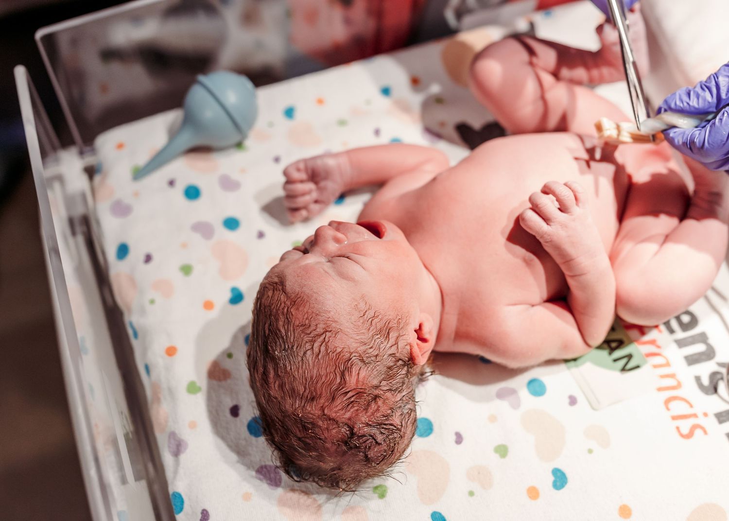 birth photographer captures newborn baby girl right after birth