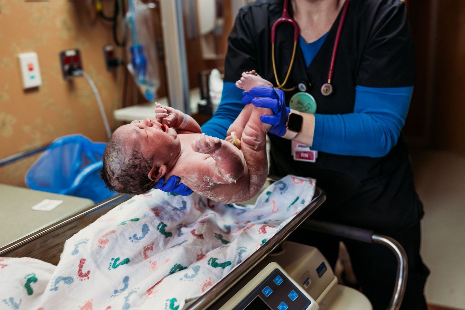 Tulsa birth photographer newborn getting cleaned up after birth in tulsa