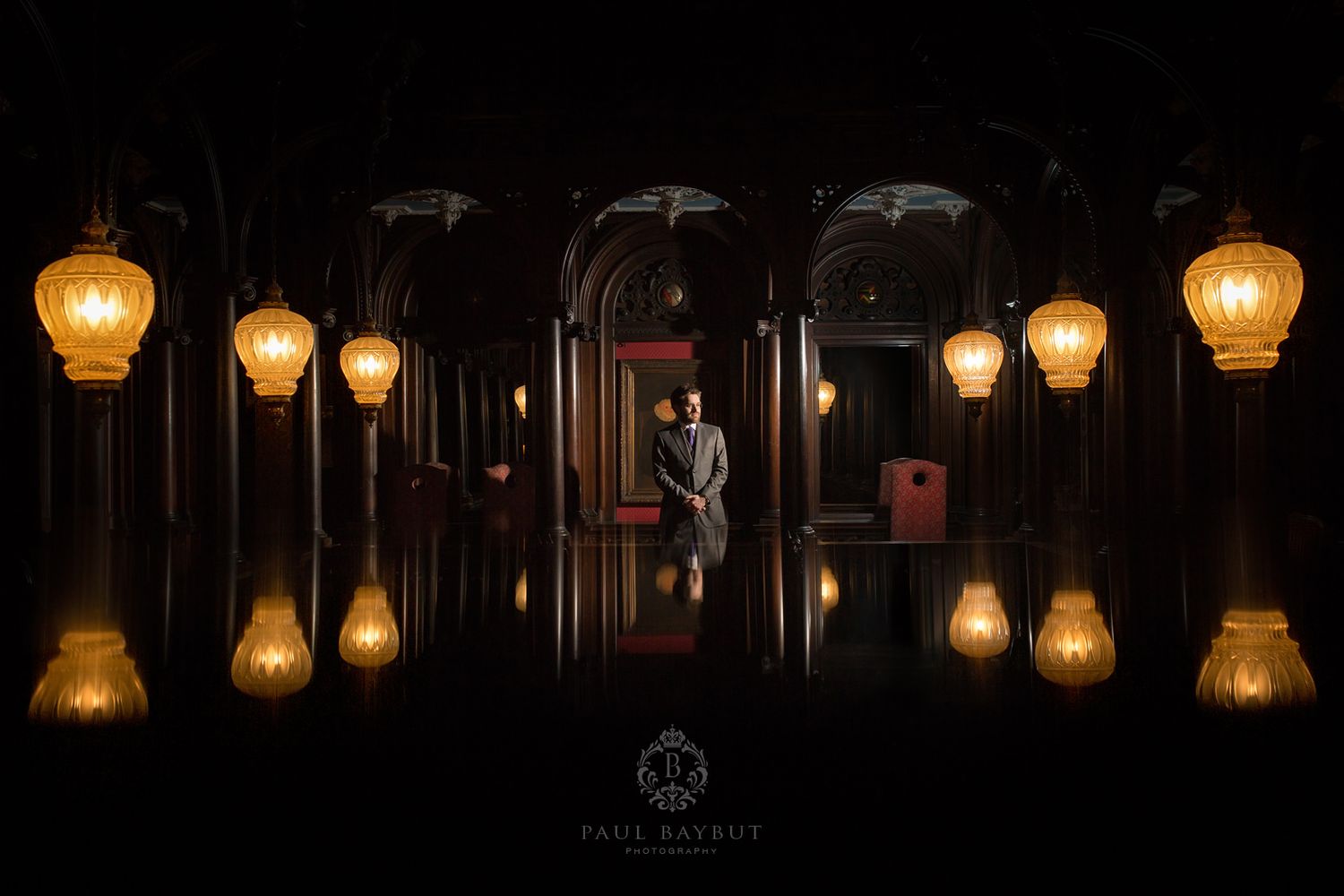 A romantic evening scene with glowing lanterns creating reflections in dark archways.