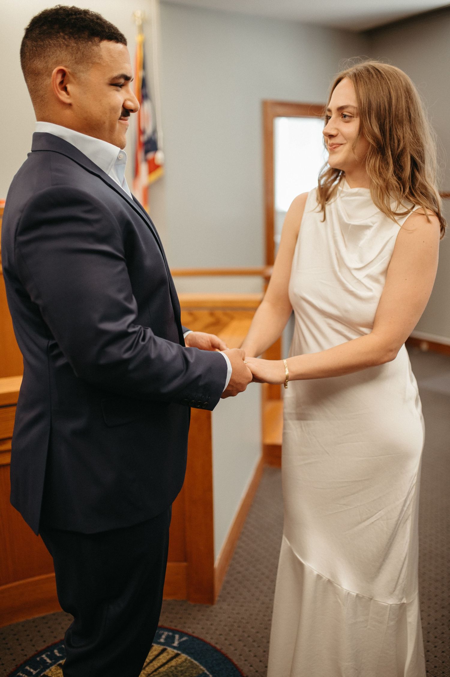 A courthouse wedding ceremony with couple in formal attire.
