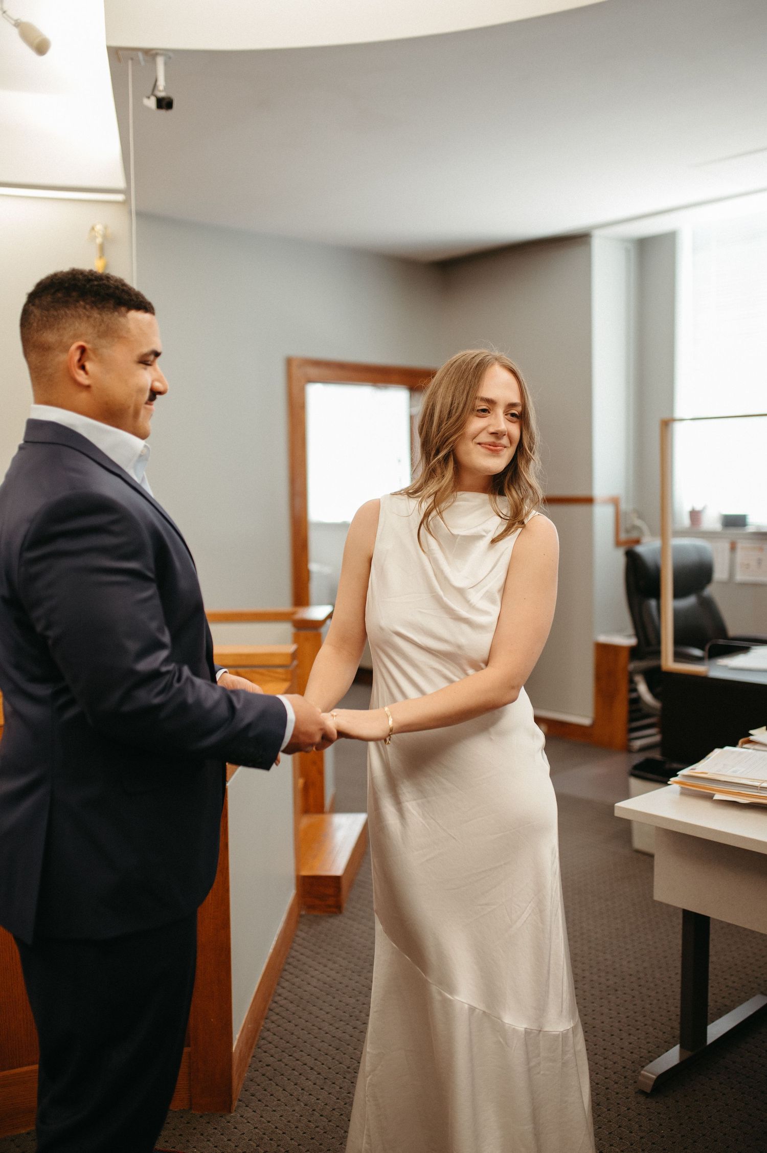 A couple exchanges vows during courthouse wedding ceremony.