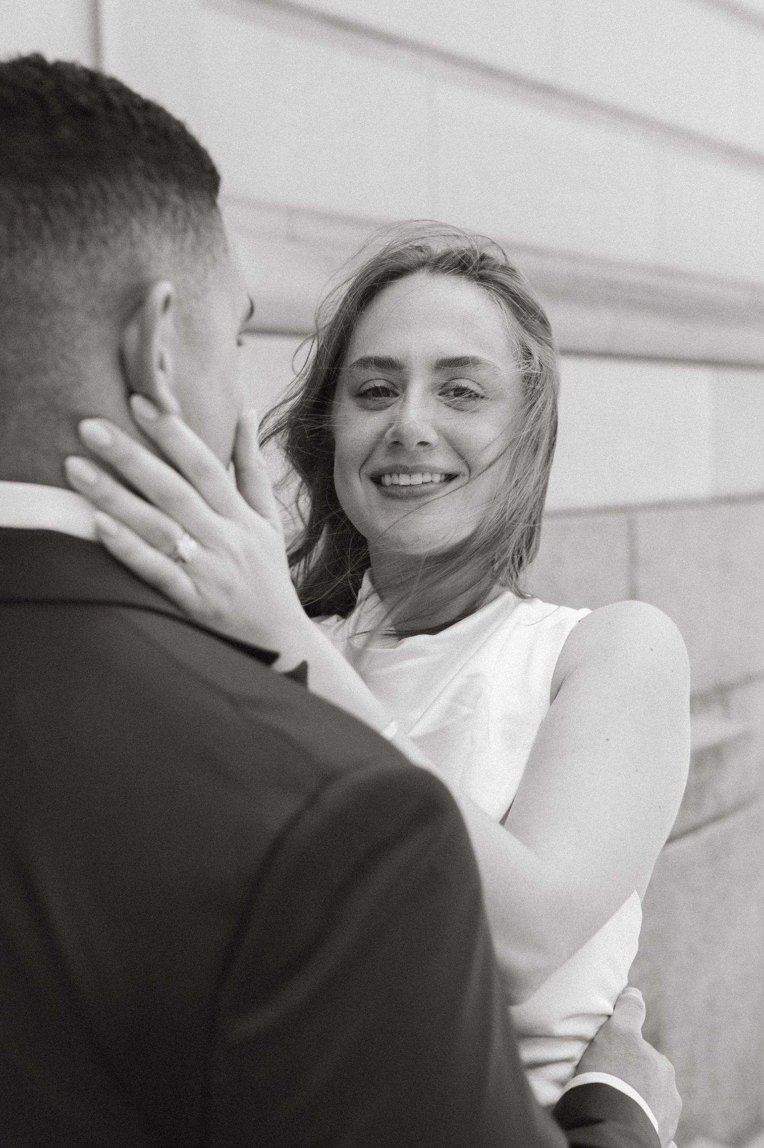 Black and white portrait of couple sharing an intimate moment outdoors.