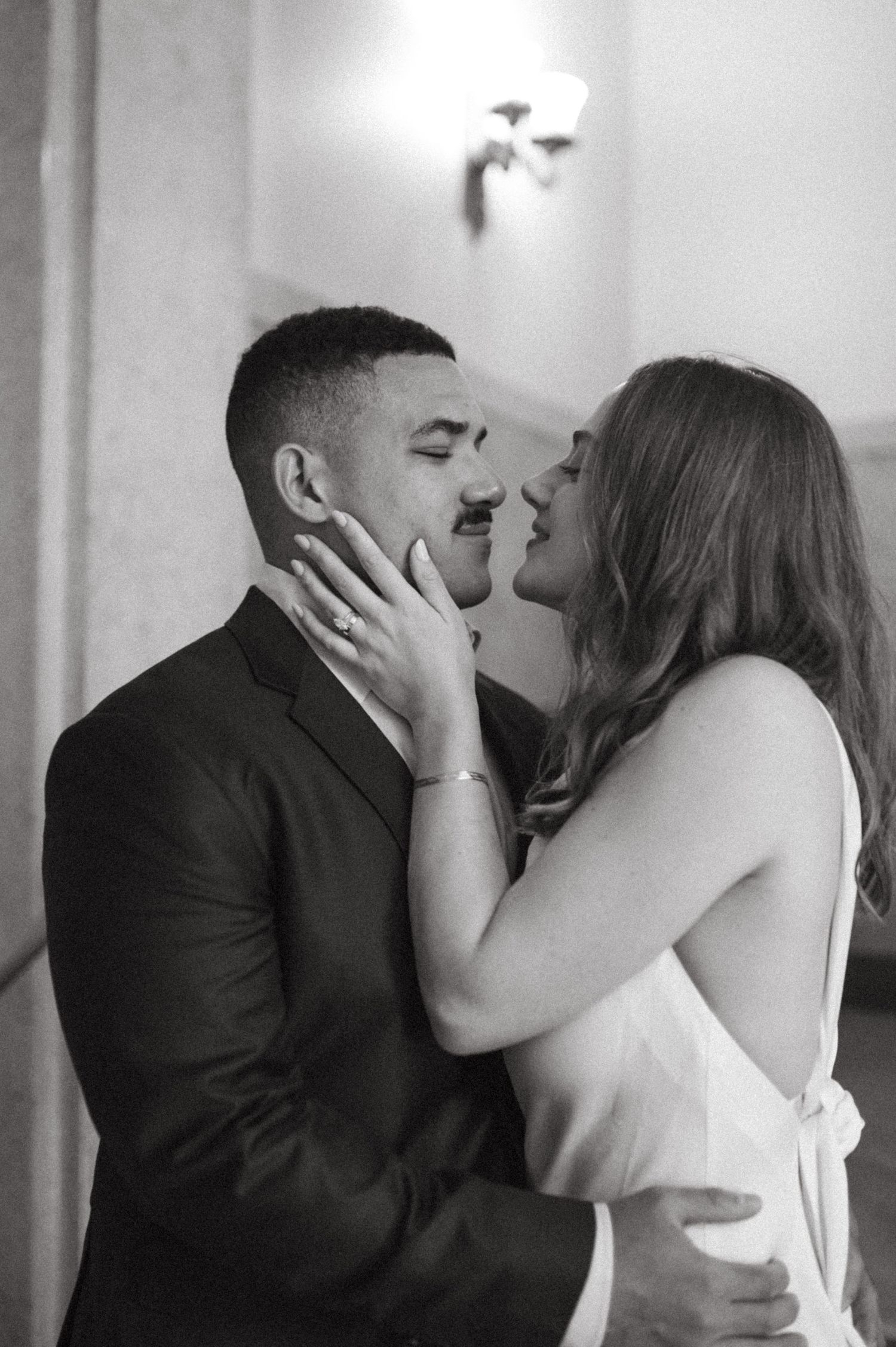 An intimate moment between a couple in formal wear sharing a tender touch.