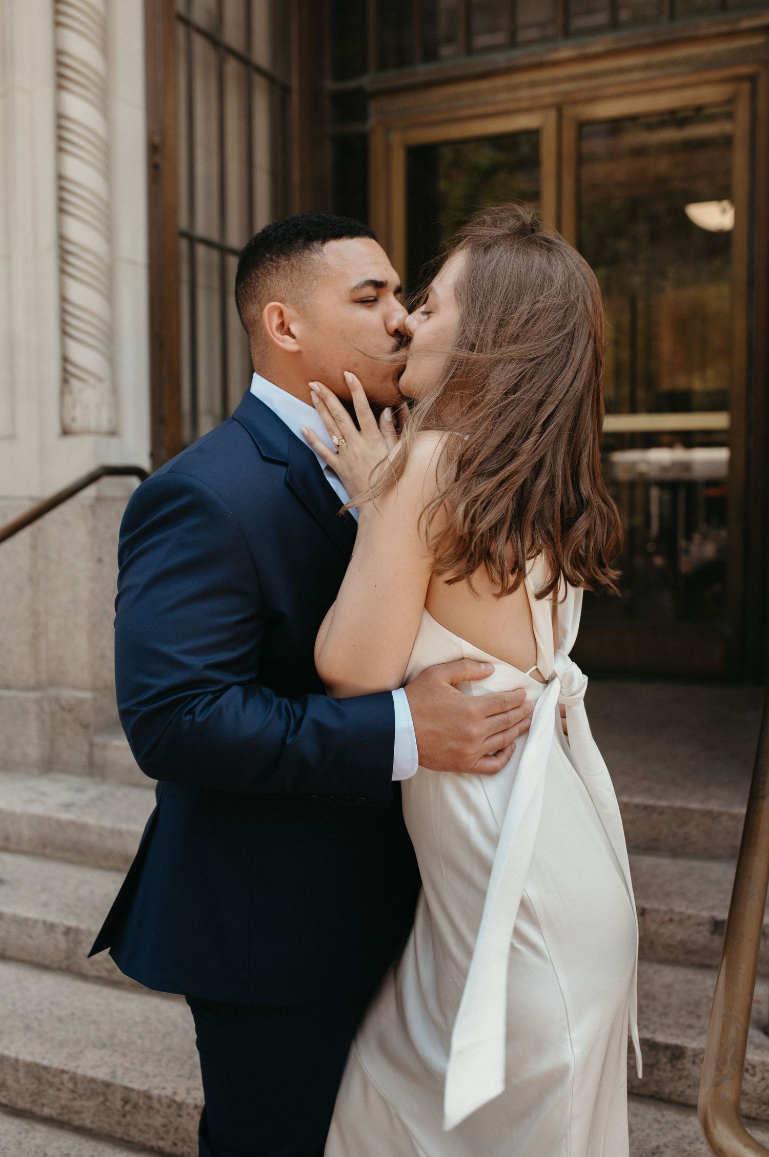 Romantic moment between newlyweds on stone steps.