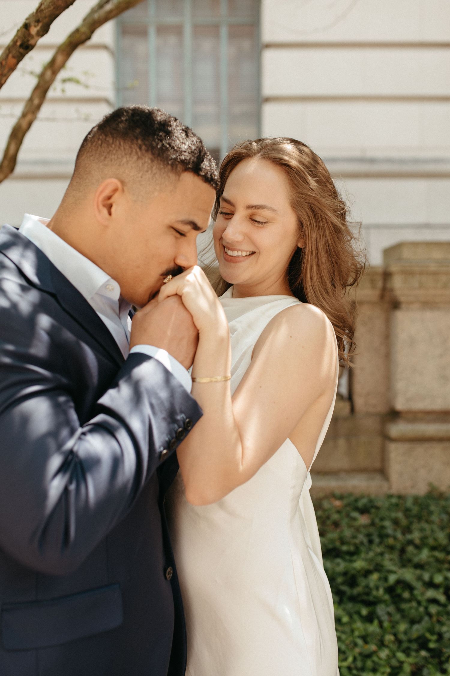 Romantic engagement portrait of couple in formal wear sharing intimate moment.
