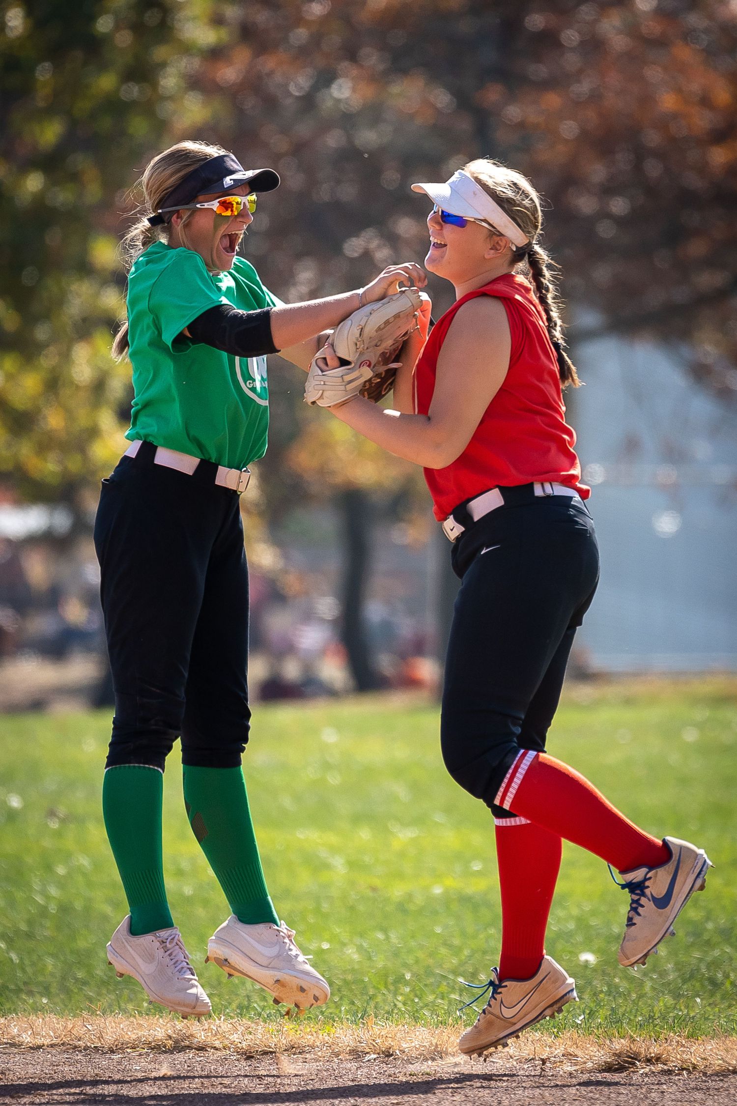 Two athletes jumping in the air celebrating. Image taken by Todd Sloan Photography.