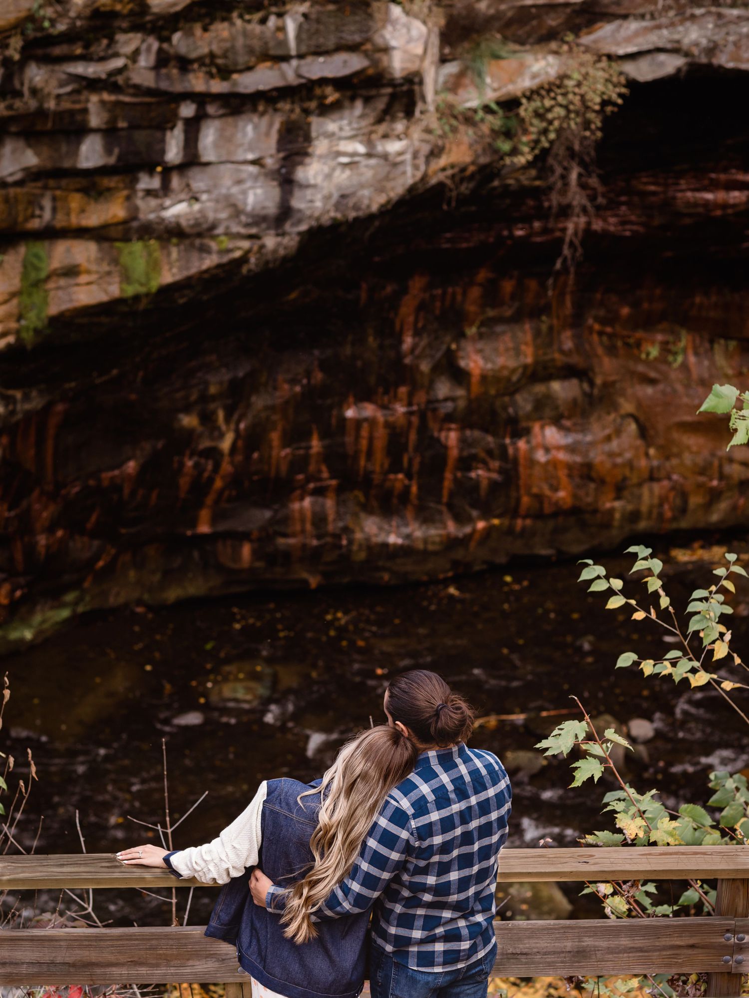 young couple embrace while looking at rocky view