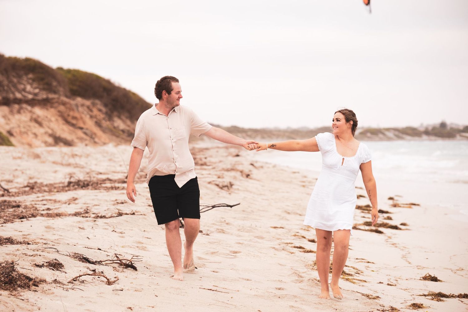 Engagement photoshoot of couple walking on Geraldton beach