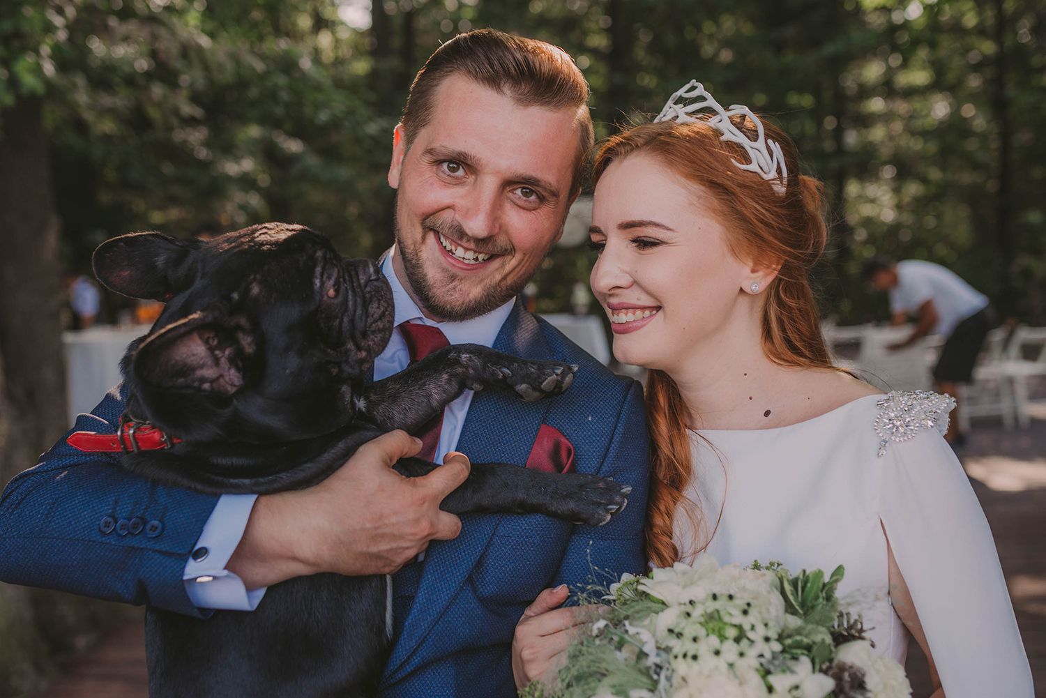 Candid wedding moments captured in a natural forest setting with vintage decor.