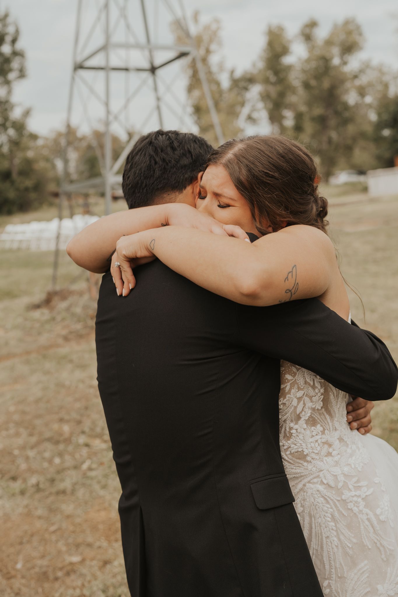Intimate embrace between newlyweds during their outdoor wedding photoshoot.