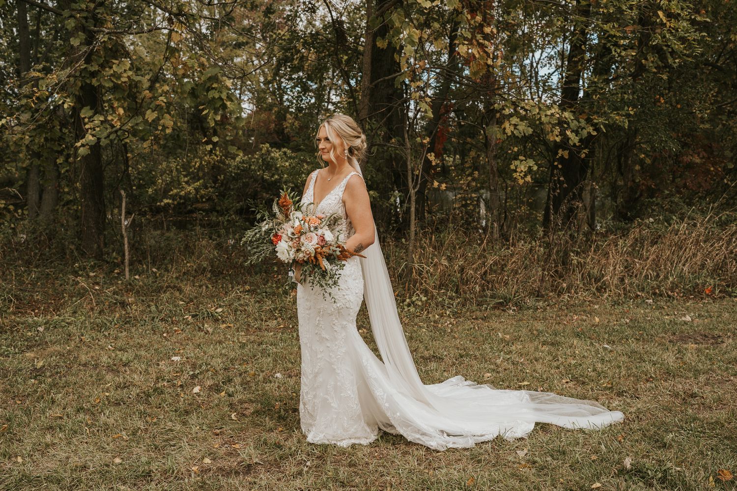 Wedding couple shares romantic moments in an autumn orchard setting.
