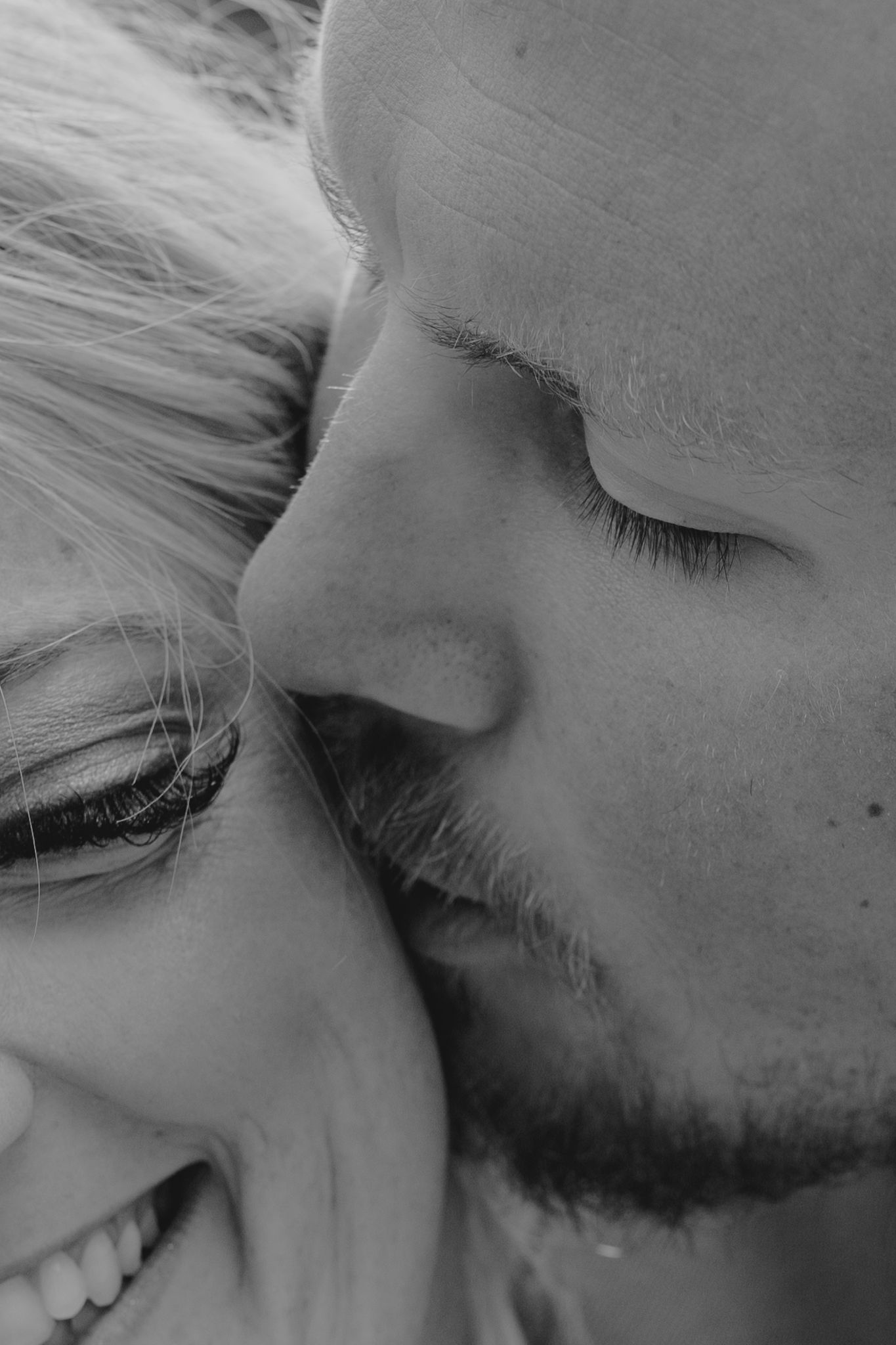 Black and white close-up portrait capturing an intimate wedding moment.