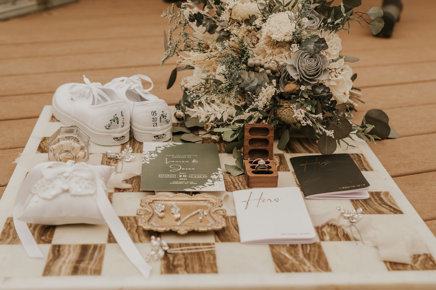Elegant wedding table setting with white floral arrangements and wooden accents.