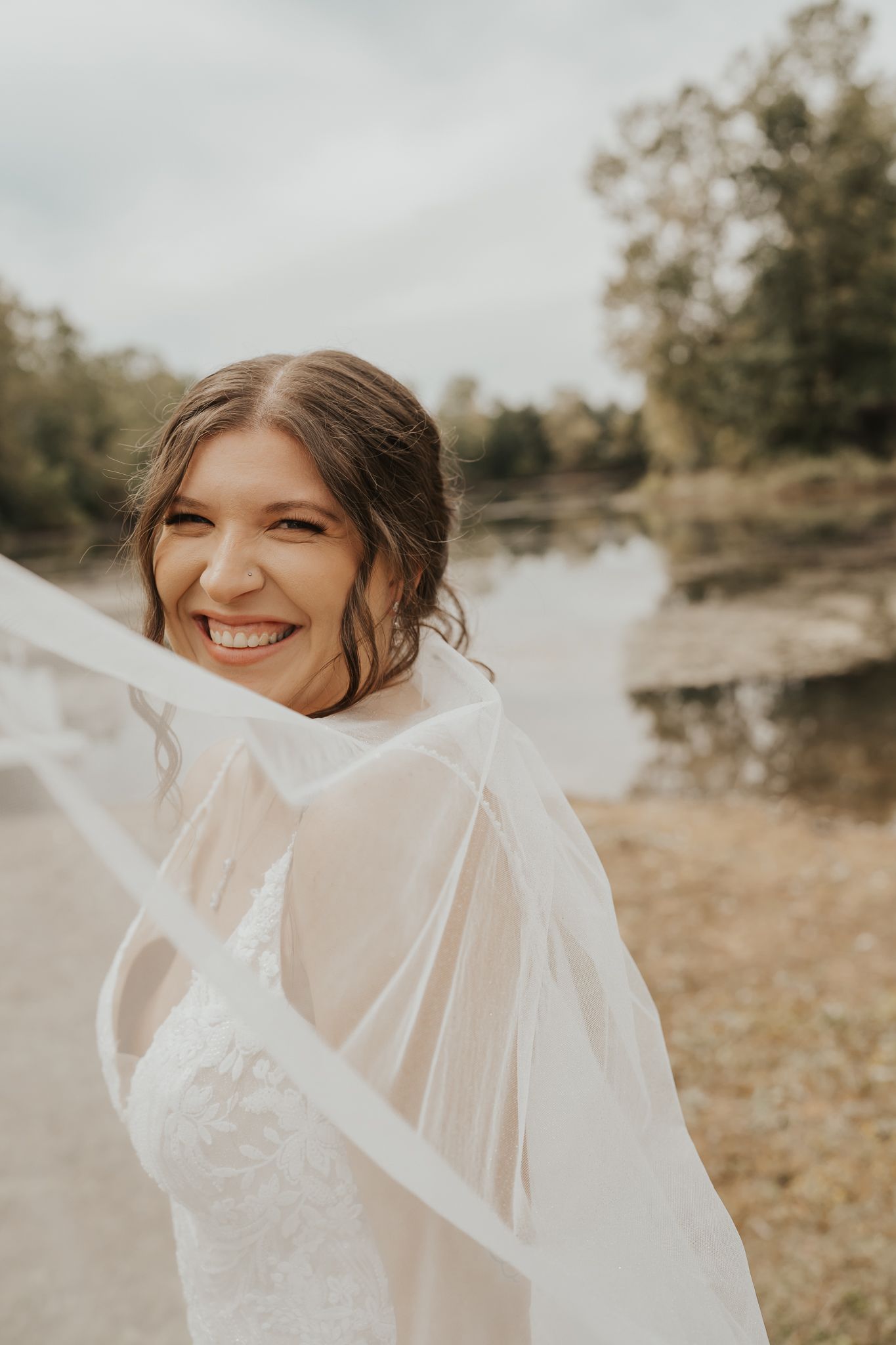 Ethereal bridal portrait with flowing veil in soft natural lighting taken in Southern MI.