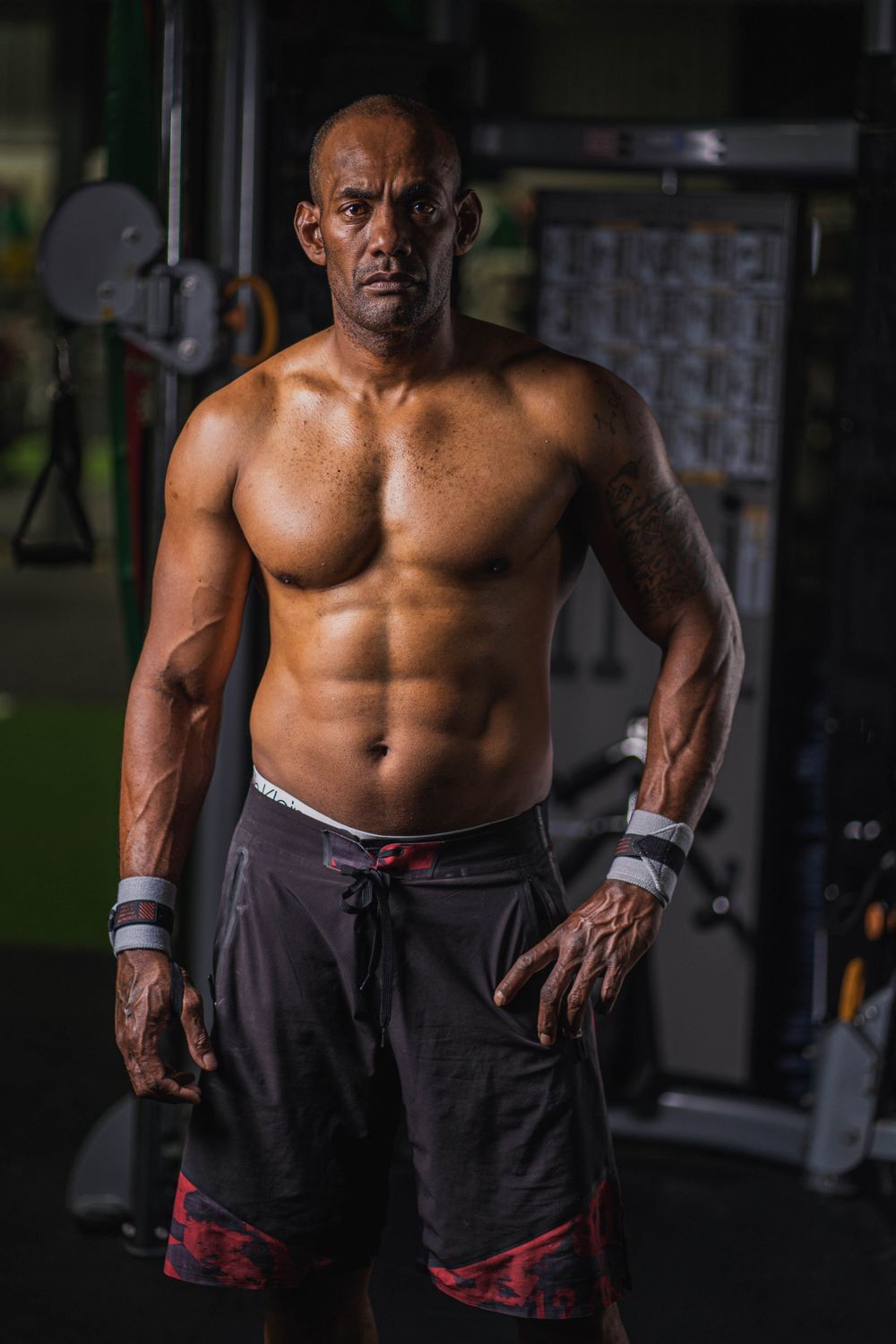 Fit athlete displaying strong physique while training in gym setting.