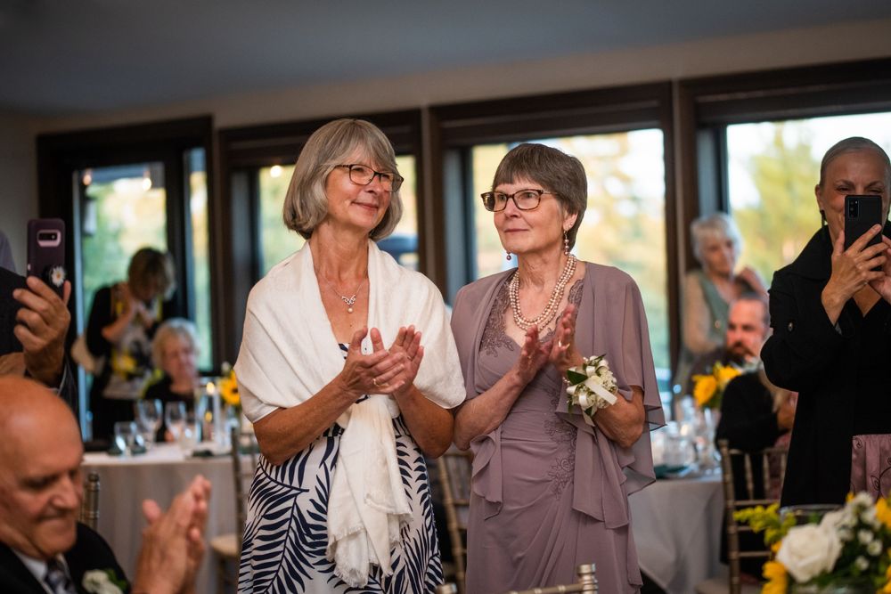 Mother of the bride clapping candid at wedding reception at Stratford Country Club