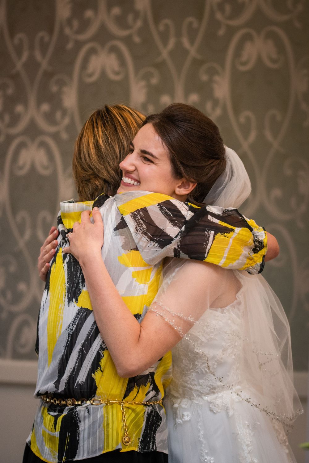 Bride hugging guest at wedding reception at Stratford Country Club