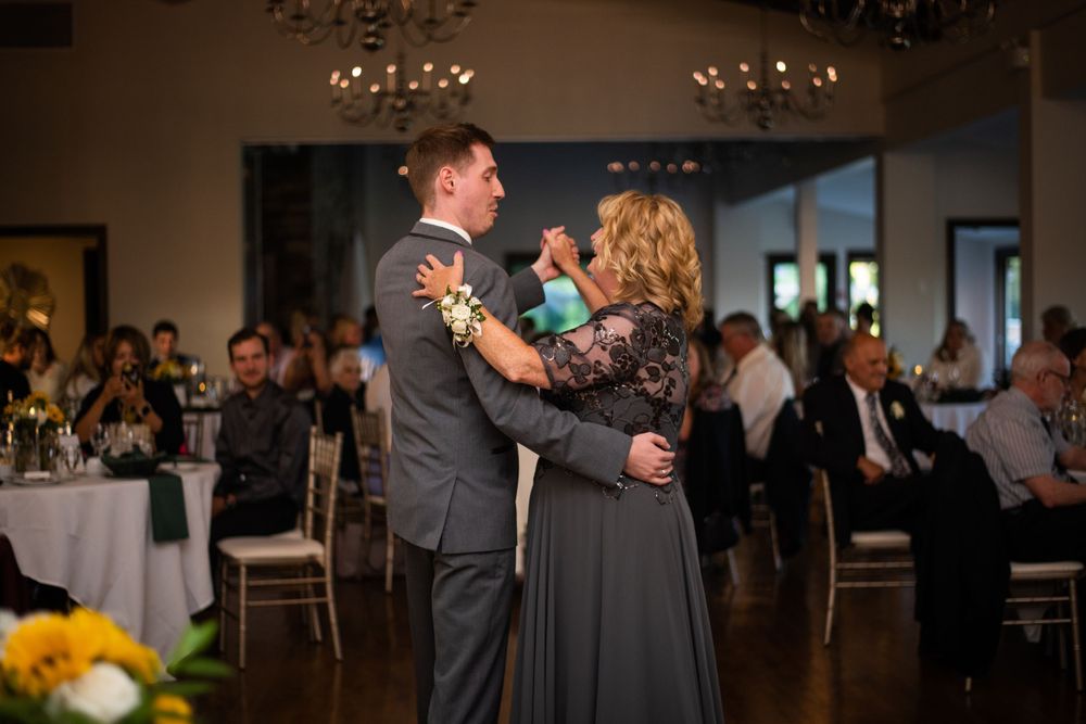 Mother and son dance with groom and mother of the groom at wedding reception at Stratford Country Club