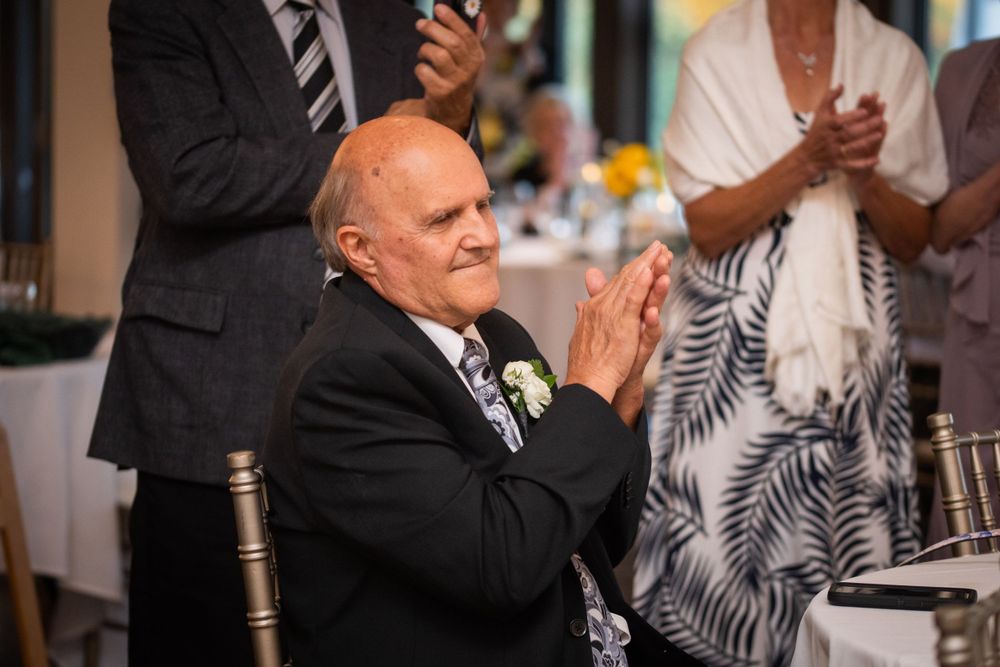 Father of the bride clapping candid at wedding reception at Stratford Country Club