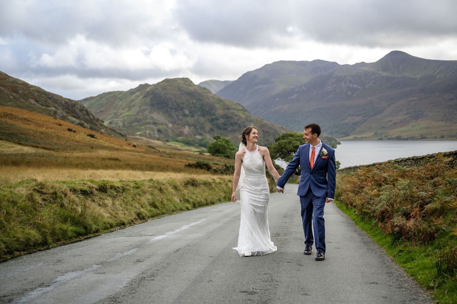 Bride and groom walking on road near New House Farm