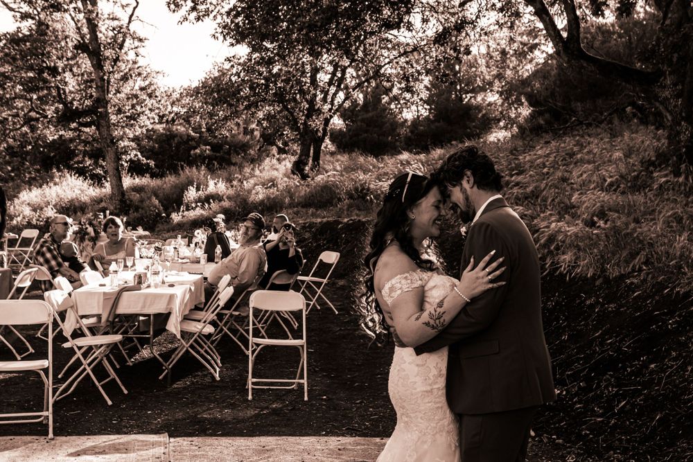 A married couple dances on the day of their commitment ceremony.  Photographed in black and white.