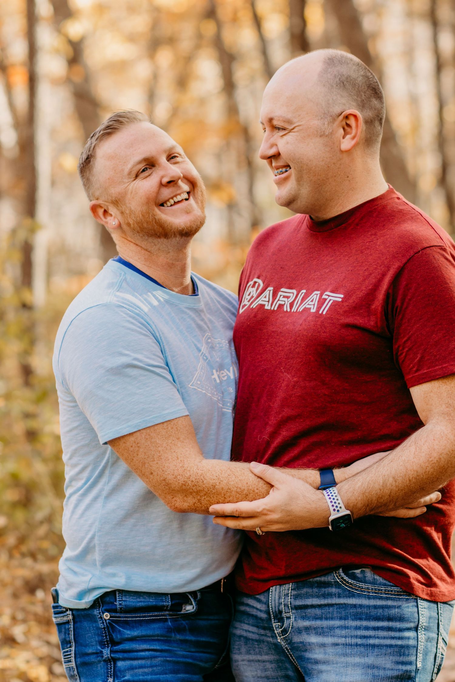 Two people share joyful moment together outdoors during fall season.