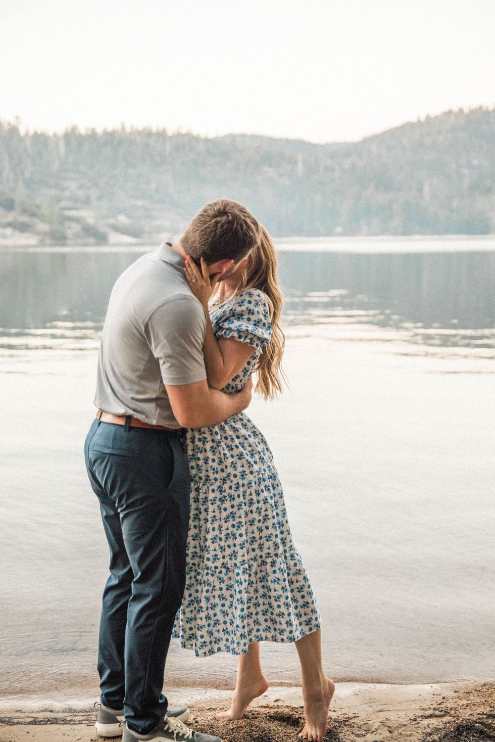 man and woman embrace  after getting engaged in Pinecrest, California
