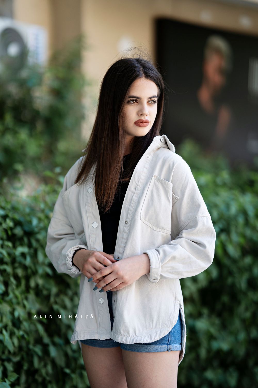 White cropped jacket and denim styling detail shot with natural garden backdrop.