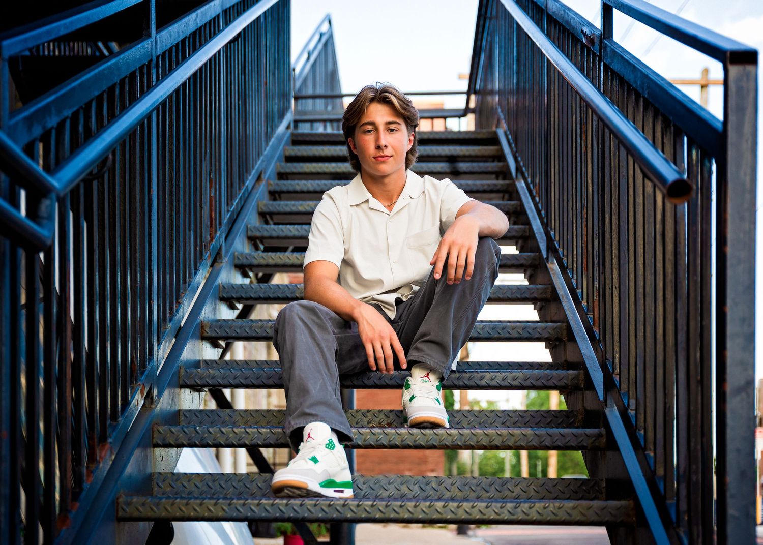 high school senior boy sitting on steps